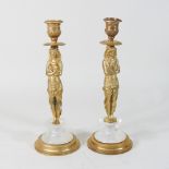 A pair of modern gilt bronze figural candlesticks, on rock crystal bases,