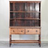 An early 20th century oak dresser, on turned legs,