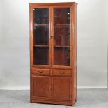 A 20th century Chinese hardwood glazed bookcase,
