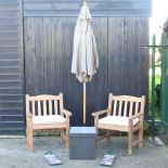 A pair of hardwood garden armchairs, with cream loose cushions, and covers,