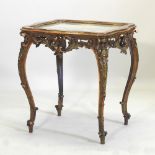 A French 19th century ornate gilt centre table, with a silkwork inset top,