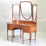 An Edwardian satinwood kidney shaped dressing table, with three mirrors above,