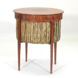 A George III mahogany ladies work table, of oval shape, with a hinged lid,