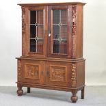 An early 20th century continental carved oak cabinet bookcase,