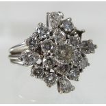 An unmarked diamond cluster ring, the central stone approximately 0.
