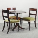 A 19th century mahogany circular occasional table, with a hinged top, on a tripod base,