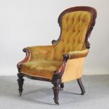 A Victorian carved mahogany yellow upholstered show frame armchair