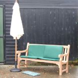 A hardwood garden bench, with green loose cushions, and cover, 183cm,