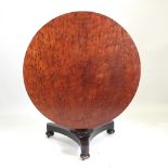 A Regency plum pudding circular mahogany breakfast table, on a platform base,