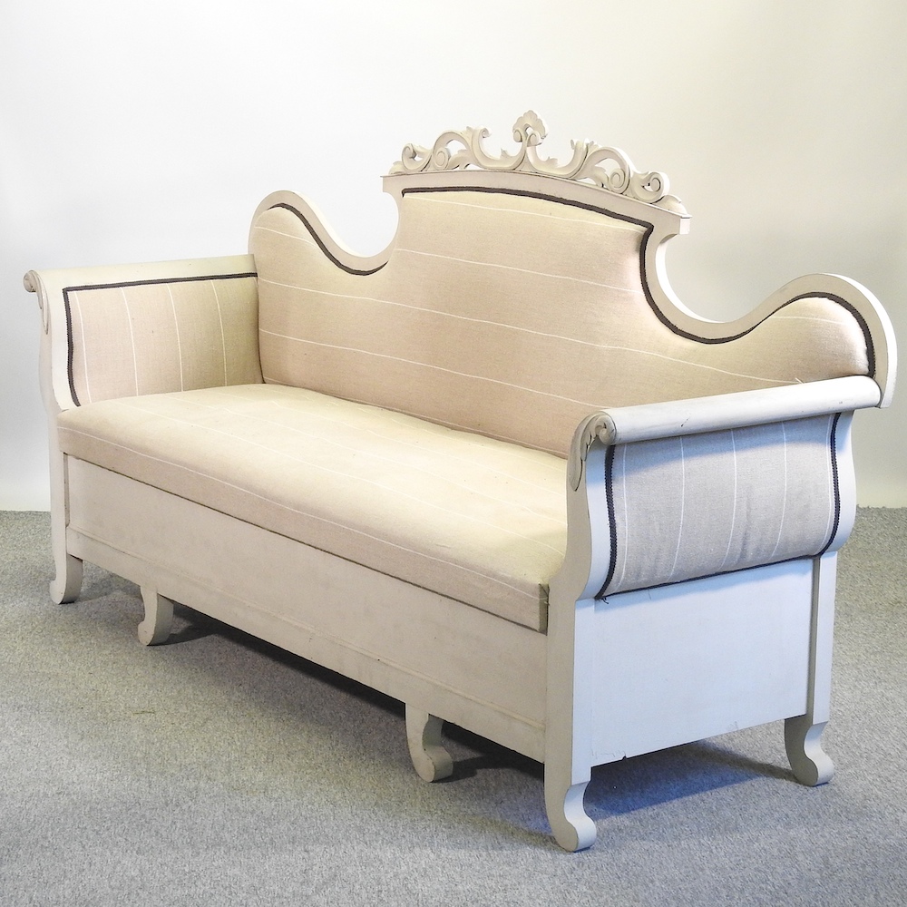 A Victorian style grey painted scroll end sofa, with an upholstered seat,