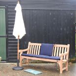 A teak garden bench, with blue loose cushions, and cover, 183cm,