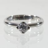 A modern platinum and diamond single stone ring, 0.