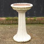 A reconstituted stone bird bath,