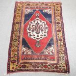A Persian shiraz rug, with a central medallion, on a red ground,