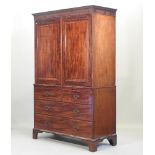 A Regency mahogany and inlaid linen press, fitted with slides, on bracket feet,