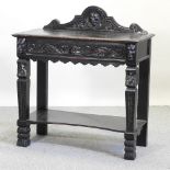 A Victorian heavily carved dark oak side table, on carved legs,