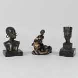 Two ethnic bronzed busts, together with a dolphin figure,