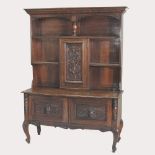 An early 20th century carved oak dresser, on cabriole legs,