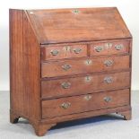 A George III oak bureau, on bracket feet,