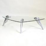 A contemporary triangular glass coffee table on aluminium legs,