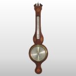 A 19th century mahogany and inlaid wheel barometer, with a silvered dial,