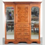 An Edwardian mahogany triple wardrobe, with mirrored doors,