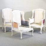 A pair of white painted wing back armchair frames,
