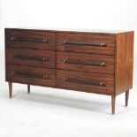 A modern chest of drawers, containing two rows of three short drawers, on tapered legs,