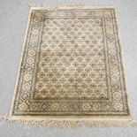 A Persian style rug, with all over design, on a beige ground,