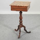 A 19th century walnut and inlaid combination games table, on a tripod base,