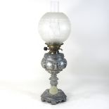 A 19th century spelter oil lamp and shade, bearing a plaque inscribed 'Presented to Mrs Myhill',