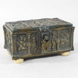 A 19th century bronze reliquary casket, with relief decoration, on ivory feet, 15cm,