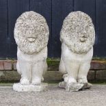 A pair of reconstituted stone gatepost finials, in the form of lions,