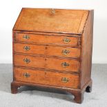 A George III oak bureau, on bracket feet,