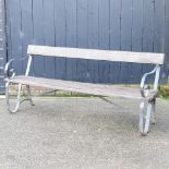A hardwood and wrought iron garden bench,