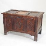 An 18th century and later carved oak coffer,