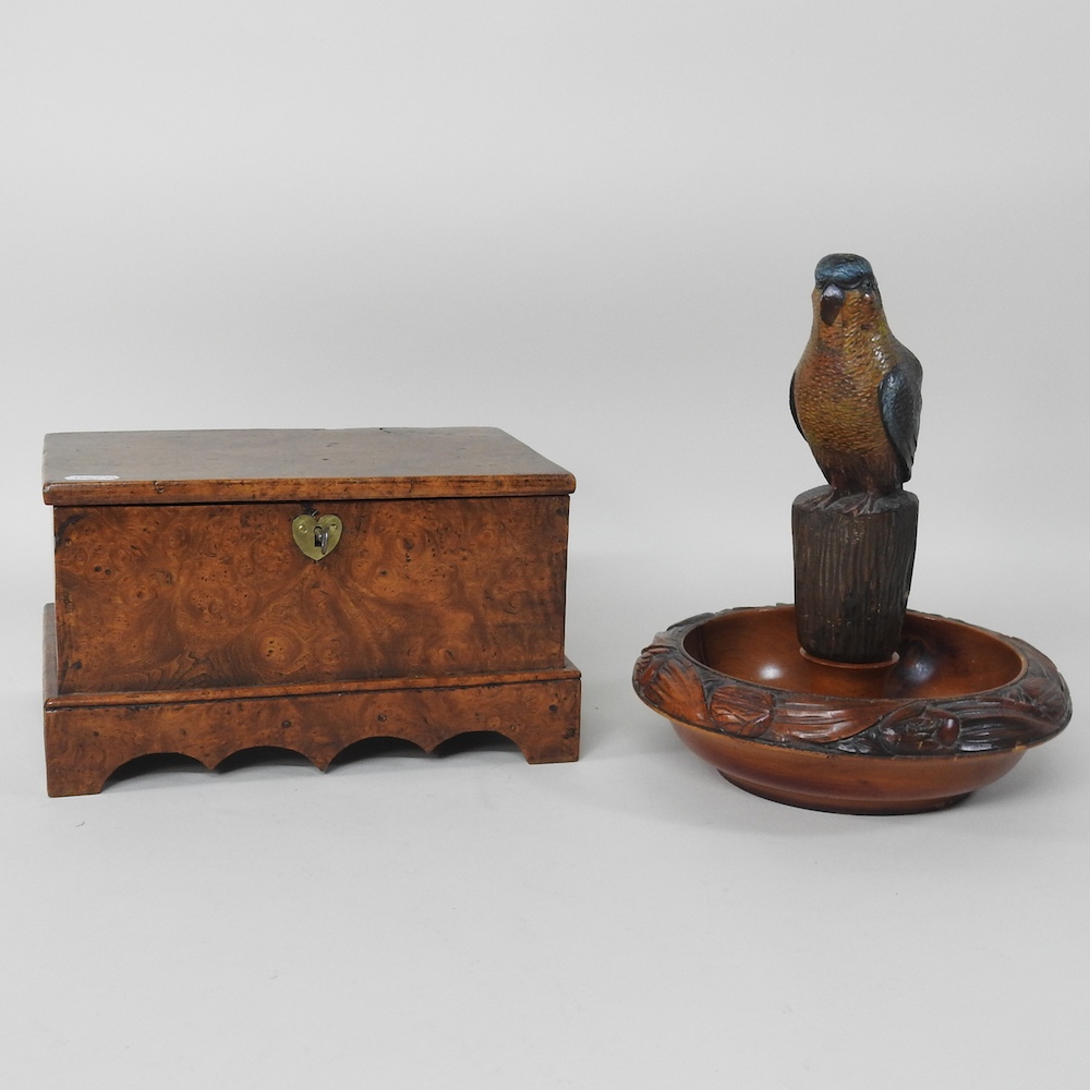 A burr walnut casket, together with a novelty nut cracker in the form of a parrot,