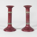 A pair of early 20th century American silver, copper and red enamelled table candlesticks,