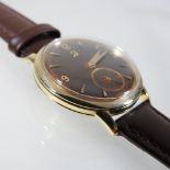 A 1950's Omega gentleman's wristwatch, having a signed brown dial,