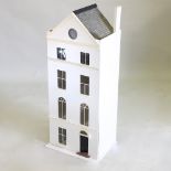 A white painted wooden doll's house,