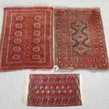 A Turkish woollen rug, with geometric designs on a red ground, 153 x 109cm,