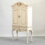 A white painted cabinet, on cabriole legs,