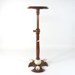 A 20th century adjustable wooden stand, the base decorated with wooden apples,