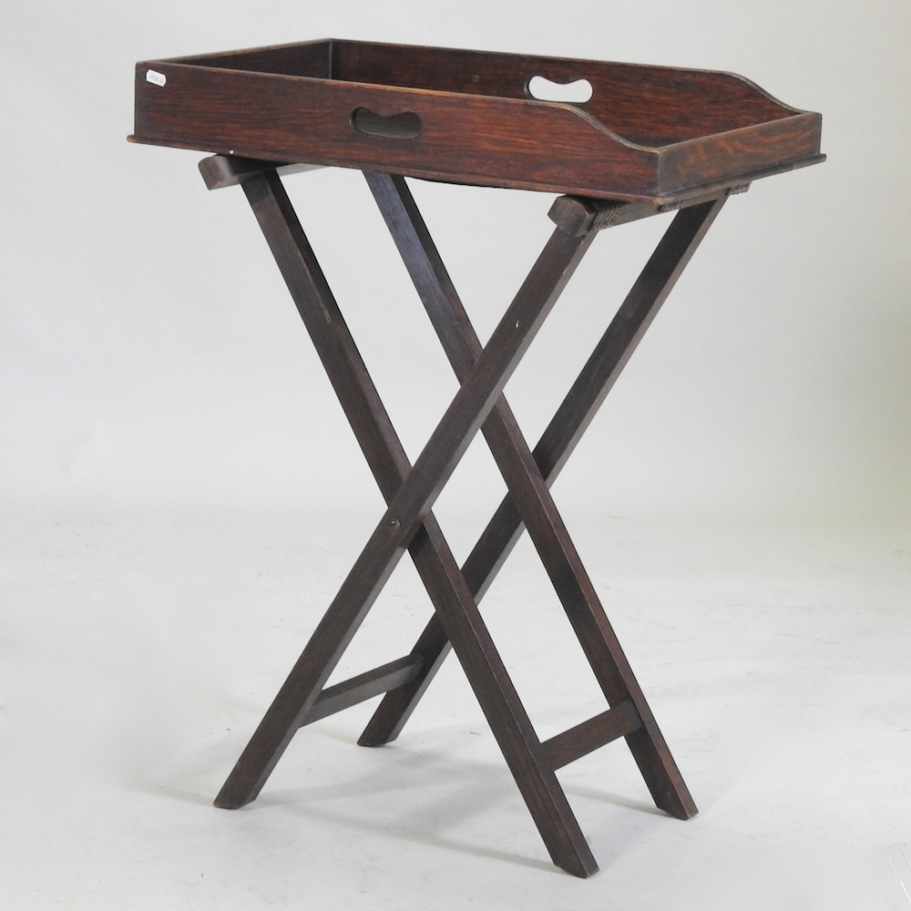 An early 20th century butlers tray, on a folding stand,
