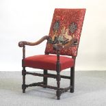 A 19th century carved oak high back tapestry upholstered armchair