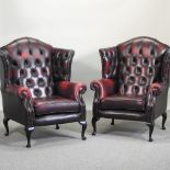 A pair of Thomas Lloyd red leather upholstered button back wing armchairs (2)