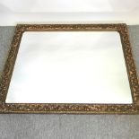 A Victorian style gilt framed wall mirror, with foliate decoration,