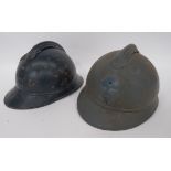 Two WW1 French Adrian Pattern Steel Helmets blue painted crown. Attached top comb. Attached front