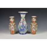 A pair of Chinese Canton famille rose vases, 19th century, the ovoid bodies beneath waisted necks