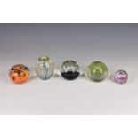 A small collection of glass paperweights, comprising three Caithness paperweights to include Morning